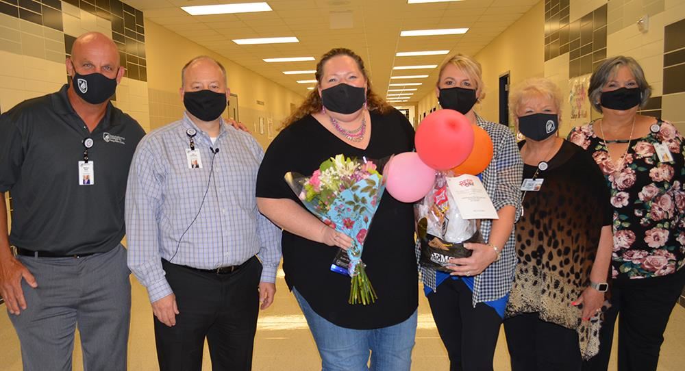 Photo of the secondary teacher of the year and administrative leaders inside Boswell high School